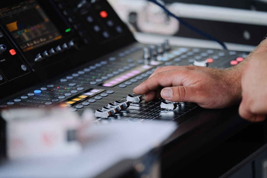 Hands operating a live video mixing console
