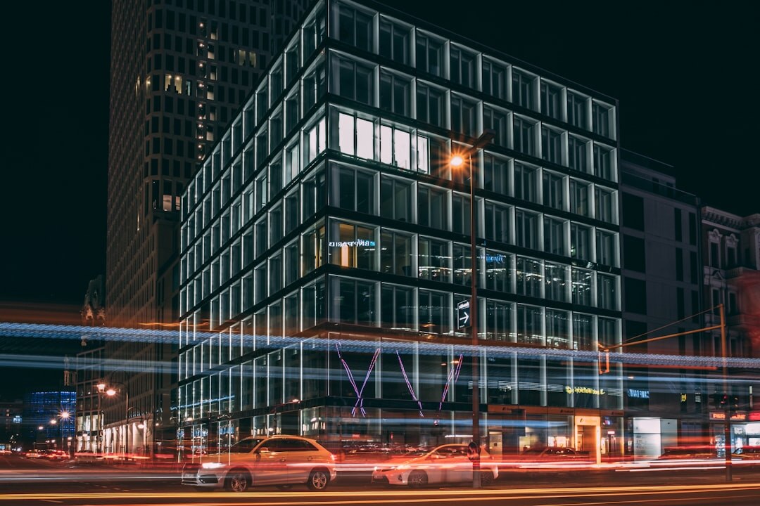 Modern glass office building exterior in the evening